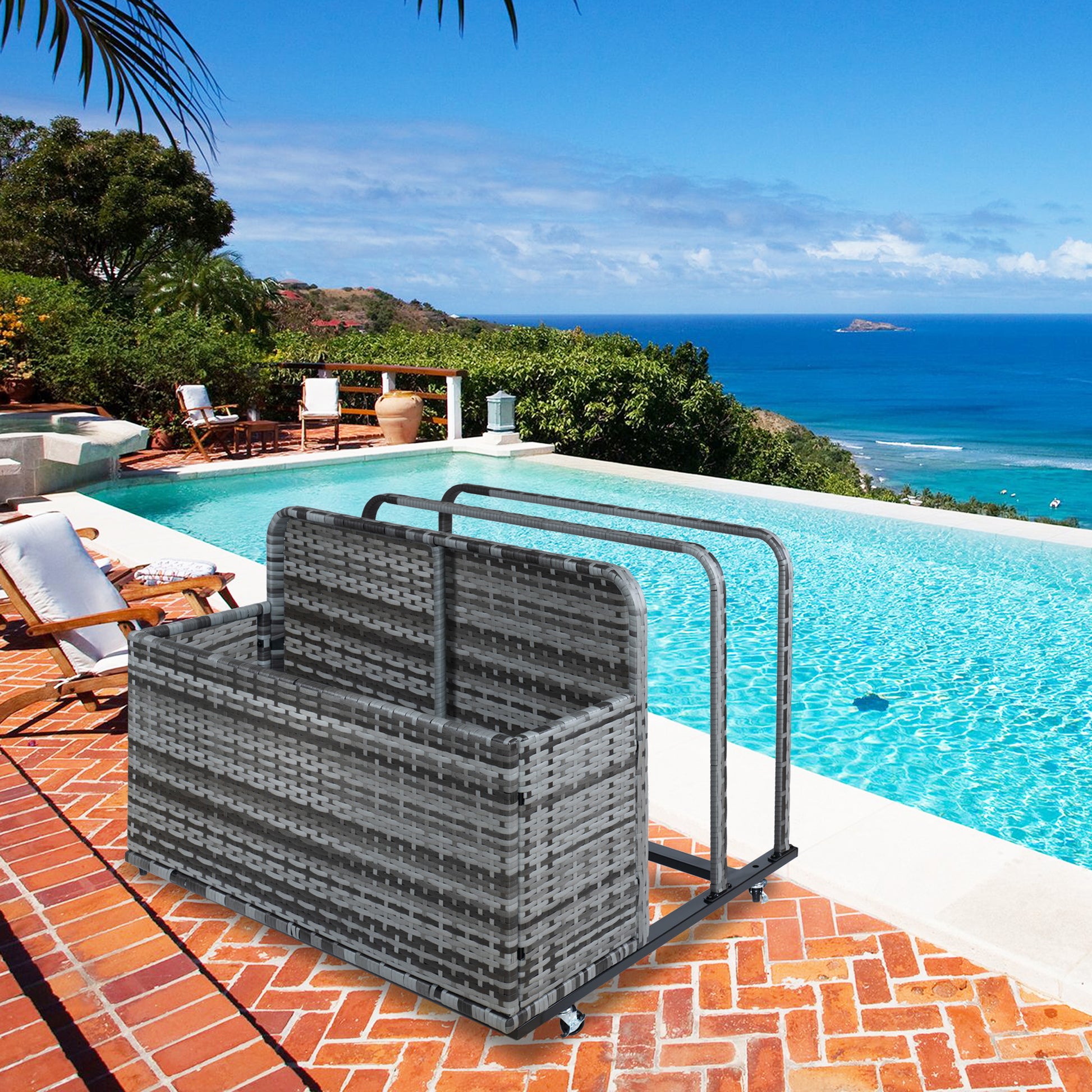 A wicker outdoor storage box filled with pool toys, placed on a grassy area next to a swimming pool with children playing and splashing.