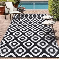 9x18 black and white geometric outdoor rug, waterproof and reversible for patios.