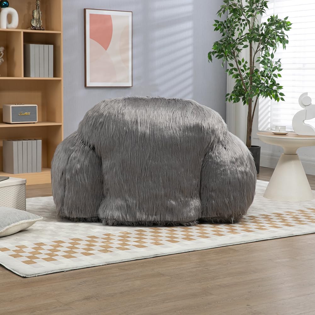 Close-up of the plush, grey faux fur fabric of the armchair, showing soft, shaggy texture.