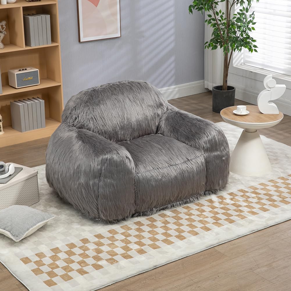 Close-up of a plush, grey faux fur armchair with soft, shaggy texture.