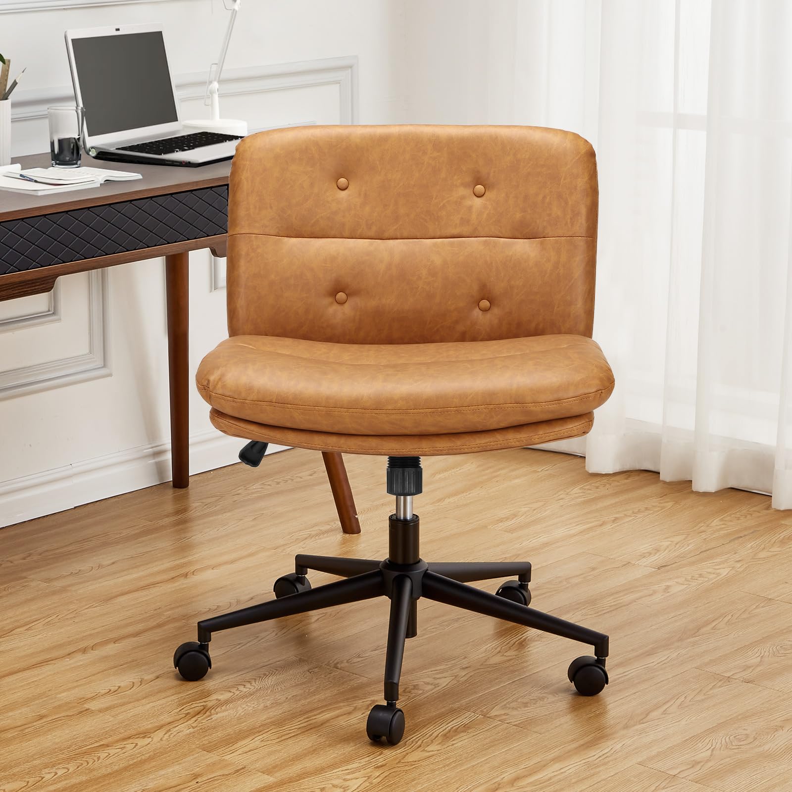 Office chair with tan faux leather upholstery, sitting on a wooden floor, with a woman sitting cross-legged on the seat, using a tablet.