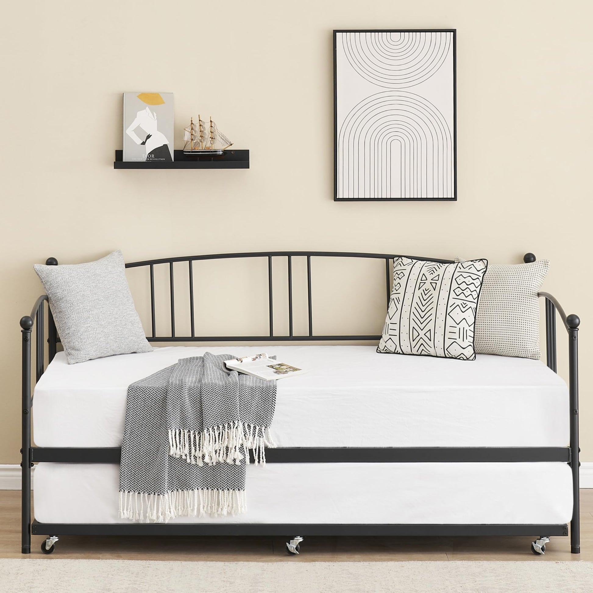Black twin metal daybed frame with pullout trundle and headboard for versatile use.