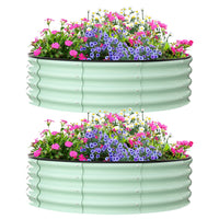 Green raised garden beds, 4ft diameter, durable steel, ideal for outdoor planting.