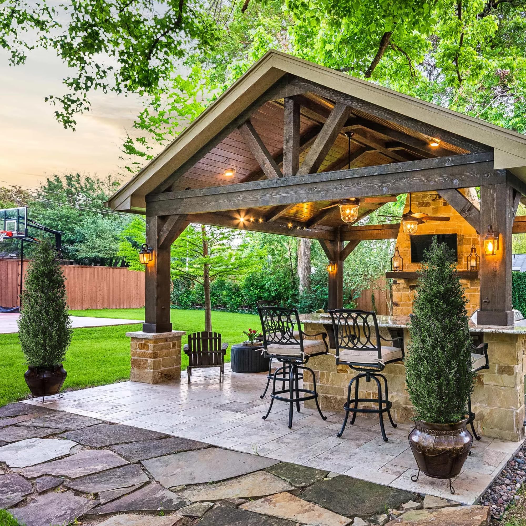 Green artificial cedar topiary trees with dense foliage and natural trunk detail