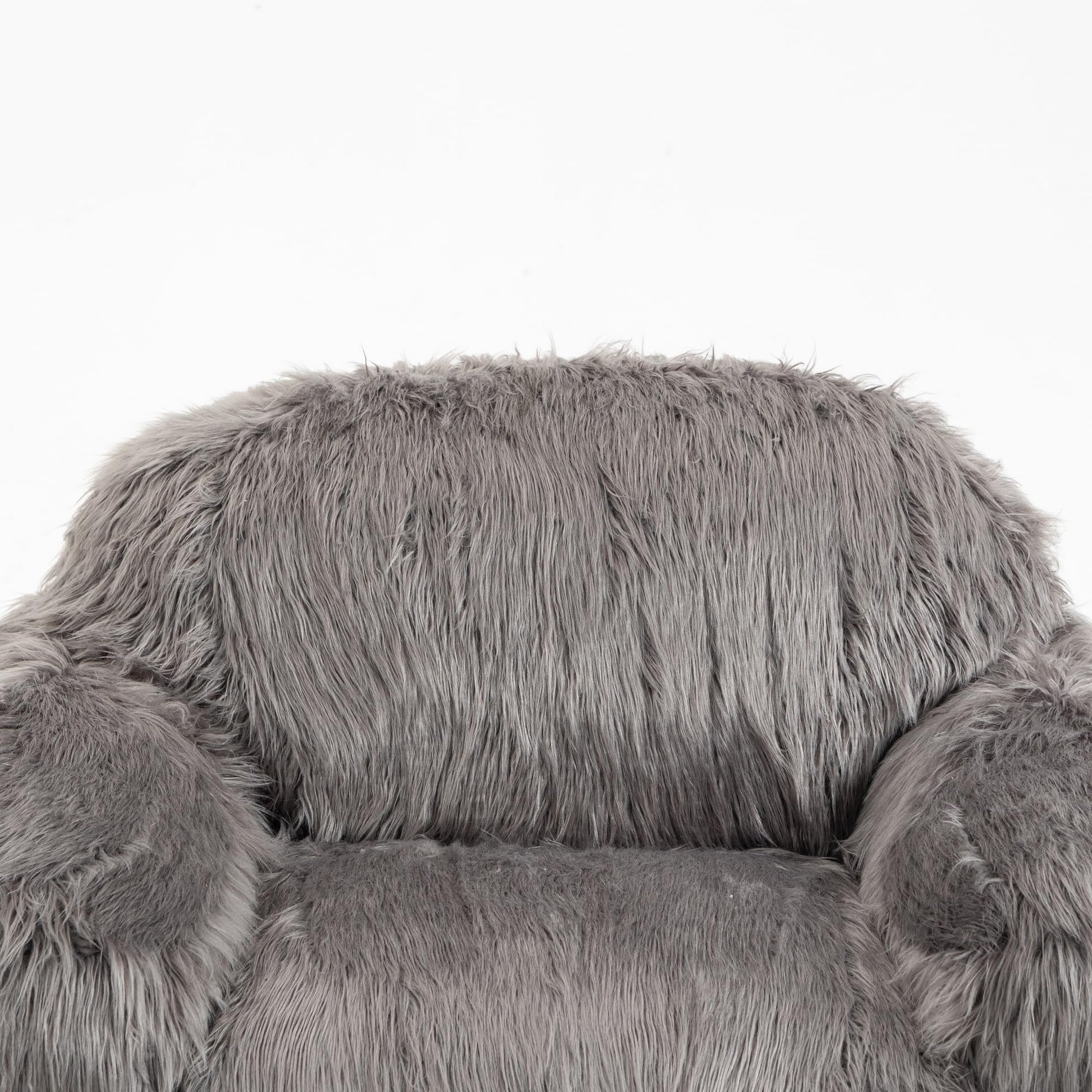 Side view of a grey faux fur plush armchair with a rounded back and armrests, soft and shaggy texture.