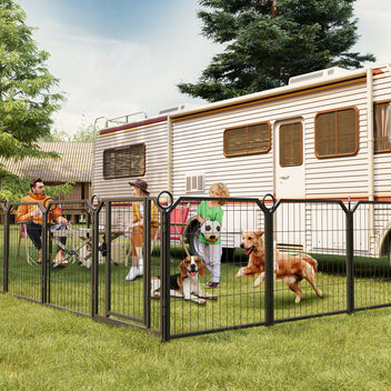 People with dogs in a fenced area near a trailer